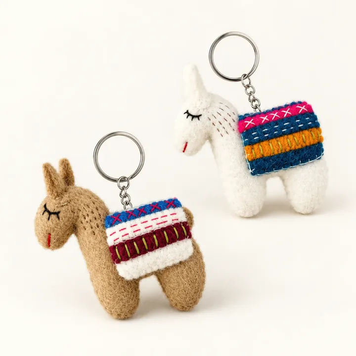 AI studio recreation: Alpaca keychains in handmade wool felt on a warm ivory background