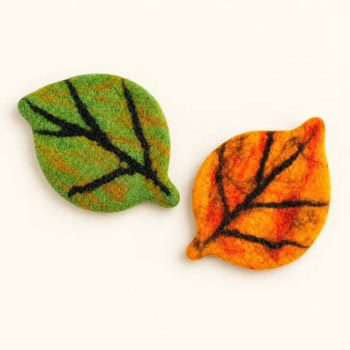 AI studio recreation: Autumn leaf coasters in handmade wool felt on a warm ivory background